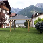 Gazebo in Legno KIOSK Tetto con tegole 629x347 cm - Antivento-37778